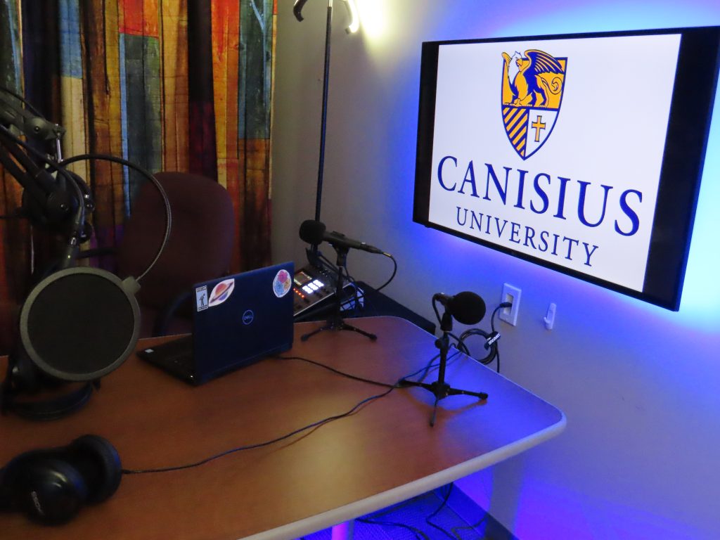 Podcast recording table with Canisius University logo