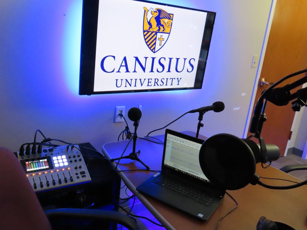 Podcast recording table with Canisius University logo, alt view